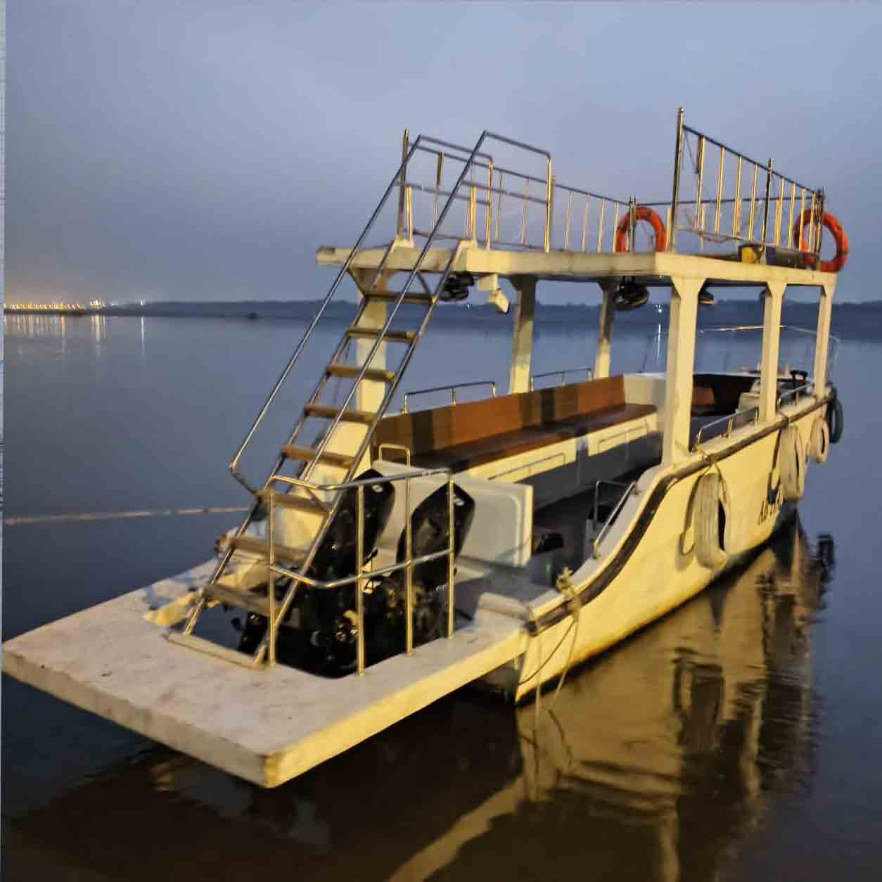 Steamer and row boats on the Ganga in Varanasi